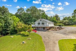 an aerial view of a house with a driveway at Trailblazer Lodge - Upscale, hot tub, trail, game room, wifi, fire pit, bar, pool table, king bed, view, pet friendly in Berkeley Springs