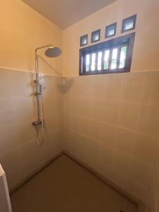 a bathroom with a shower and a window at Greenfield-Lombok in Tetebatu