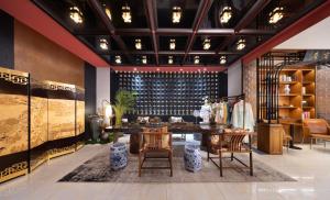 a room with a table and chairs and a wine rack at Beijing TangFu Chinese Culture Boutique Hotel Sanlitun Embassy Area in Beijing