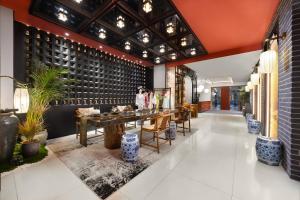 a restaurant with a table and chairs in a lobby at Chinese Culture Boutique Hotel TangFu, Liangma Riverside, Near Sanlitun & Embassy Area, Metro Access, 20min to Wangfujing, Forbidden City & Tian'anmen Square, Airport & the Great Wall Travel Assistance in Beijing