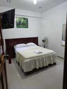 Ένα ή περισσότερα κρεβάτια σε δωμάτιο στο Hospedaje Paraíso