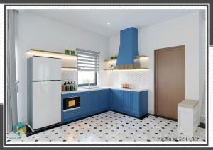 a kitchen with blue cabinets and a white refrigerator at Villa Malibu Tropicana Hồ Tràm in Xuyên Mộc +11 photos