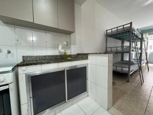 a kitchen with a sink and a bunk bed at 3 min da Praia de Copacabana - Apartamento Compartilhado PR in Rio de Janeiro