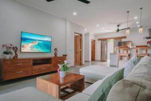 a living room with a couch and a tv at Villa Royal in Singaraja
