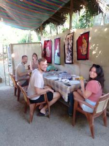 a group of people sitting at a table at Imaa freedom house in Nilwella