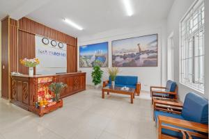 a living room with a fireplace and blue chairs at Nhà Khách 683 - Only 10m to Mikazuki - 50m to the Beach in Da Nang