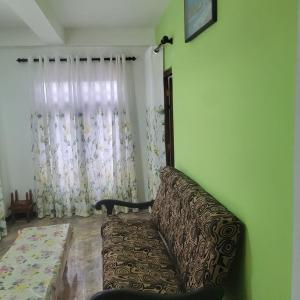 a living room with a couch and a window at Policekanda View in Diyatalawa