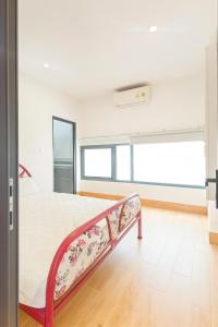 a bedroom with a bed with a floral bed frame at Happy Garden Hồ Tràm in Ho Tram