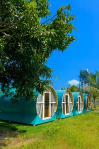 a row of circular windows on a blue house at Happy Garden Hồ Tràm in Ho Tram