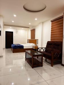 Una sala de estar con una cama, un sofá y una mesa. en Kenza Retreat, en Vagamon