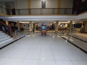 a large lobby with a vase of flowers on the floor at Dgria Family Hotel by TripleTree in Banjar