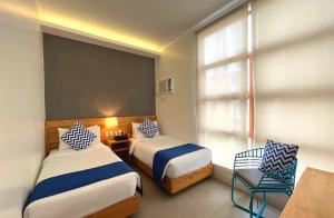 a hotel room with two beds and a chair at Bay's Inn Resort in Baler +58 photos