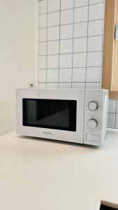 a microwave oven sitting on top of a kitchen counter at 함덕우리집 in Hamdŏng-ni