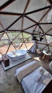 a large tent with a bath tub in a room at Zaca Domos l Ouro Preto - MG in Mariana