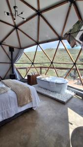 a room with a bed and a tub in a tent at Zaca Domos l Ouro Preto - MG in Mariana +7 photos