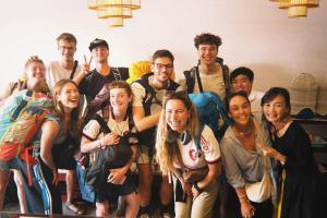 a group of people posing for a picture at Sanga Rooftop Hostel in Pakse +29 photos