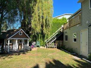 un cortile con una piccola casa e un albero di Surrey Home - King George Blvd & Rapid Transit - Airport 25 Min - Free Parking & Wi-Fi a Surrey