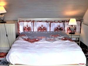 a bedroom with a large bed with red and white sheets at Charmant T3 au cœur du village pour 5 personnes - FR-1-761-31 in Villard-de-Lans +2 photos