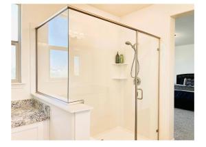 a shower with a glass door in a bathroom at Cozy Private master bedroom in a single family house in Elk Grove