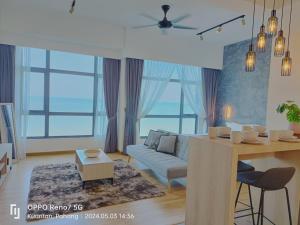a living room with a couch and a table at Kuantan Imperium seaview cityview by Avenzee in Kuantan