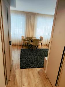 a dining room with a table and chairs at Apartamentai šalia miesto centro in Telšiai