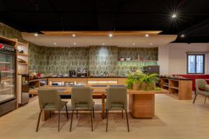 a kitchen with a large wooden table and chairs at Tago Airport Hotel in Ho Chi Minh City