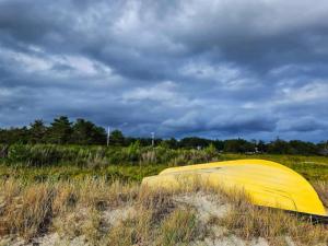 una tenda gialla in un campo sotto un cielo nuvoloso di 4 person holiday home in Knebel a Knebel