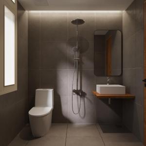 a bathroom with a shower and a toilet and a mirror at Indochine Gloria Home by Silk Path in Hanoi