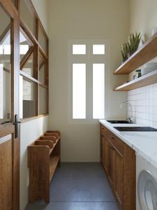 a kitchen with a sink and a window at Indochine Gloria Home by Silk Path in Hanoi