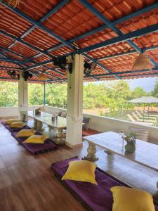 a living room with a table and yellow pillows at 360 Agonda in Agonda