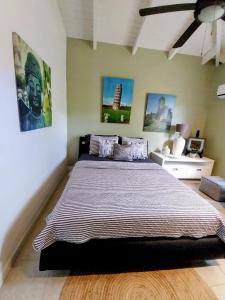 a bedroom with a large bed in a room at 2 Bedroom Dream Cottage-Point Blanche in Philipsburg +28 photos