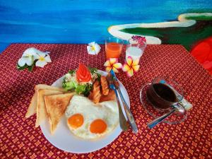 a plate of breakfast food with eggs and toast at Phulanta Resort in Ko Lanta Yai