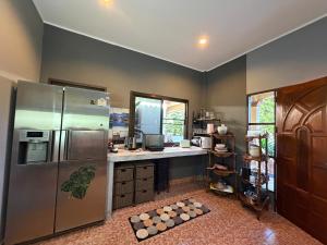 a kitchen with a stainless steel refrigerator and a counter at Beachfront bungalow south of Phuket in Phuket Town