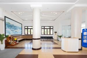 a lobby with a large column in a building at Hawaii Resort Phu Quoc in Phu Quoc +69 photos