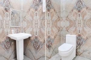 a bathroom with a toilet and a sink at Collection ORudrapurBus StandFormerly Corinthian in Rāmpura