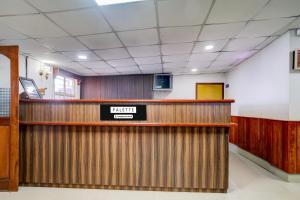 a waiting room with a raider sign on the wall at Palette Hotel And Resort Garikhana Shillong Formerly Council Lodge in Shillong