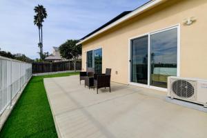 a patio with chairs and a air conditioner next to a house at Bright Spacious Modern Getaway in San Diego