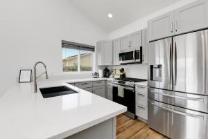 a kitchen with white cabinets and a white counter top at Bright Spacious Modern Getaway in San Diego