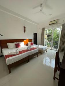 Ένα ή περισσότερα κρεβάτια σε δωμάτιο στο Sea cloud guesthouse dalawella +5 φωτογραφίες