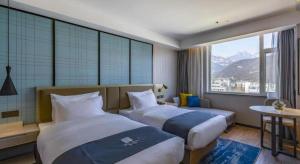 Ένα ή περισσότερα κρεβάτια σε δωμάτιο στο Echarm Hotel Tai'an Taishan Tianwai Village Hongmen +229 φωτογραφίες