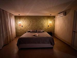 阿西斯港Hojarasca Lodge的卧室配有一张带两盏灯的墙壁床。