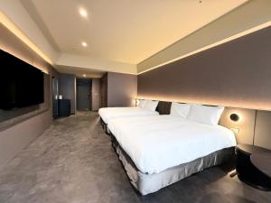 Postel nebo postele na pokoji v ubytování Hub Hotel Xintai + 5 fotografií