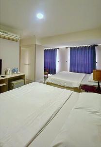 En eller flere senge i et værelse på MUI NE BOUTIQUE