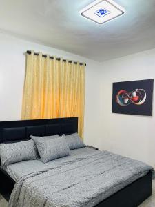 a bedroom with a bed and a ceiling at Sam Apartment 