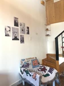 a bedroom with a bed and pictures on the wall at P&B Homestay - Đà Lạt in Da Thanh