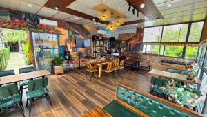a restaurant with tables and chairs in a room at MILAN Boutique Garden in Vung Tau