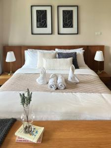 a bedroom with a large white bed with two slippers at 1minBTSThonglor:NearEmDistrict|Balcony|Washer|WiFi in Khlong Toei