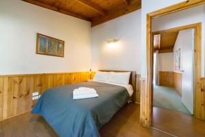 a bedroom with a bed with two towels on it at Awonga Cottages in Halls Gap