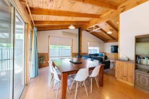 a dining room and living room with a table and chairs at Awonga Cottages in Halls Gap