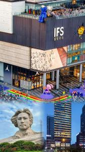 Meisu Huanman Hotel Changsha IFS Wuyi Square Branch في تشانغشا: مبنى كبير امامه تمثال